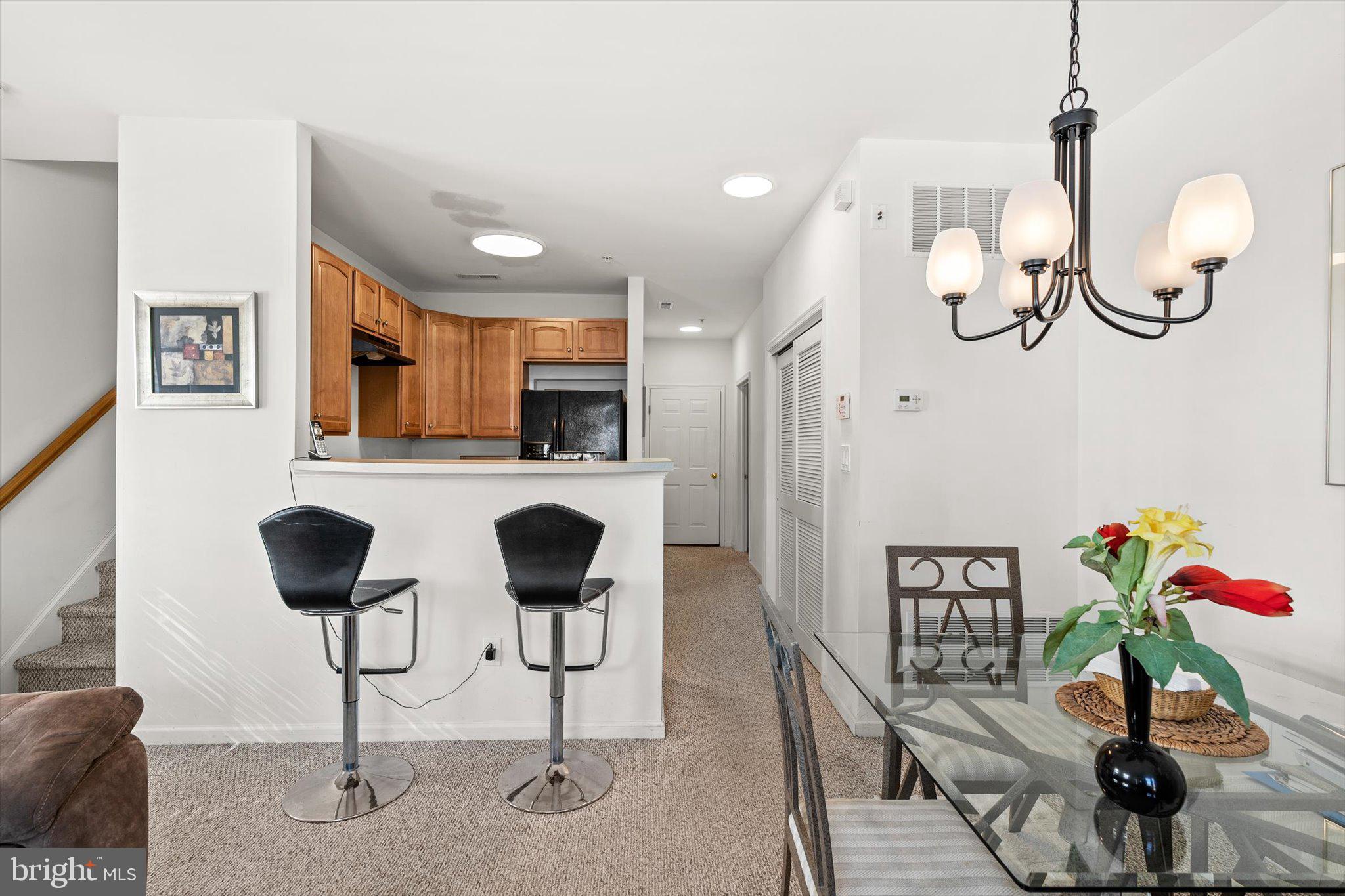 13 River Lane Delanco, NJ 08075 - Photo 10 of 19 a kitchen with stainless steel appliances kitchen island granite countertop a table chairs in it and wooden floors