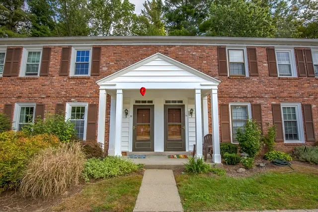 a view of house with a yard and plants