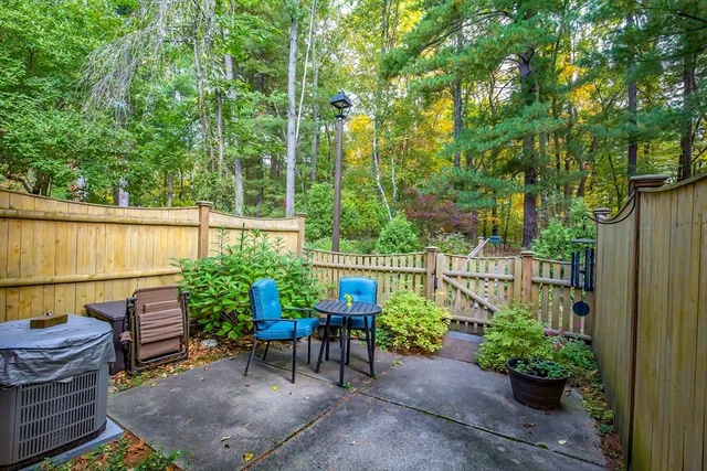 a view of a chair and table in backyard