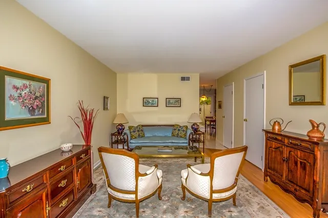 a living room with furniture a piano and a flat screen tv