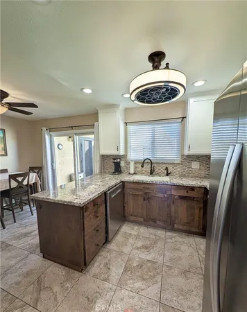 a large kitchen with a stove a sink dishwasher and a refrigerator