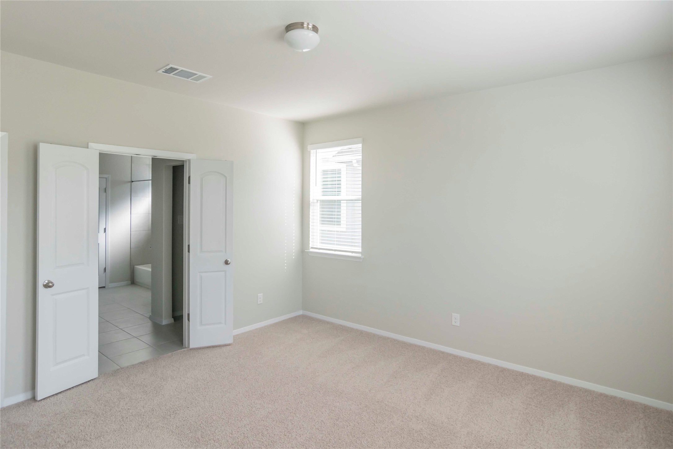 1257 Goforth Road Kyle, TX 78640 - Photo 9 of 33 Unfurnished bedroom with light colored carpet and baseboards