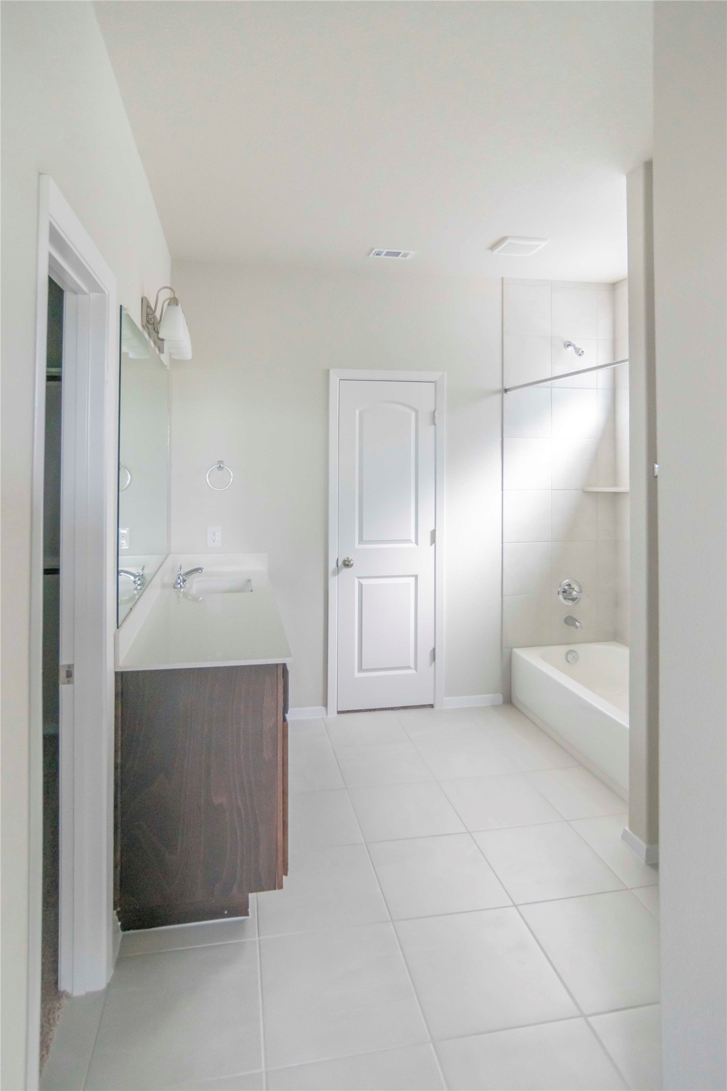 1257 Goforth Road Kyle, TX 78640 - Photo 11 of 33 Bathroom featuring vanity, light tile patterned floors, and bathing tub / shower combination