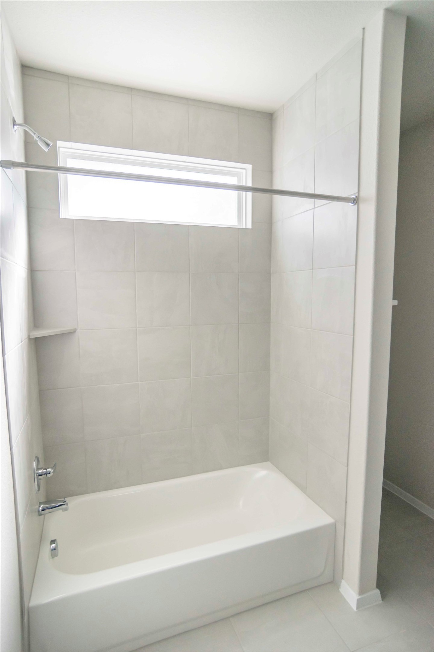 1257 Goforth Road Kyle, TX 78640 - Photo 13 of 33 Bathroom with shower / tub combination, plenty of natural light, and tile patterned flooring