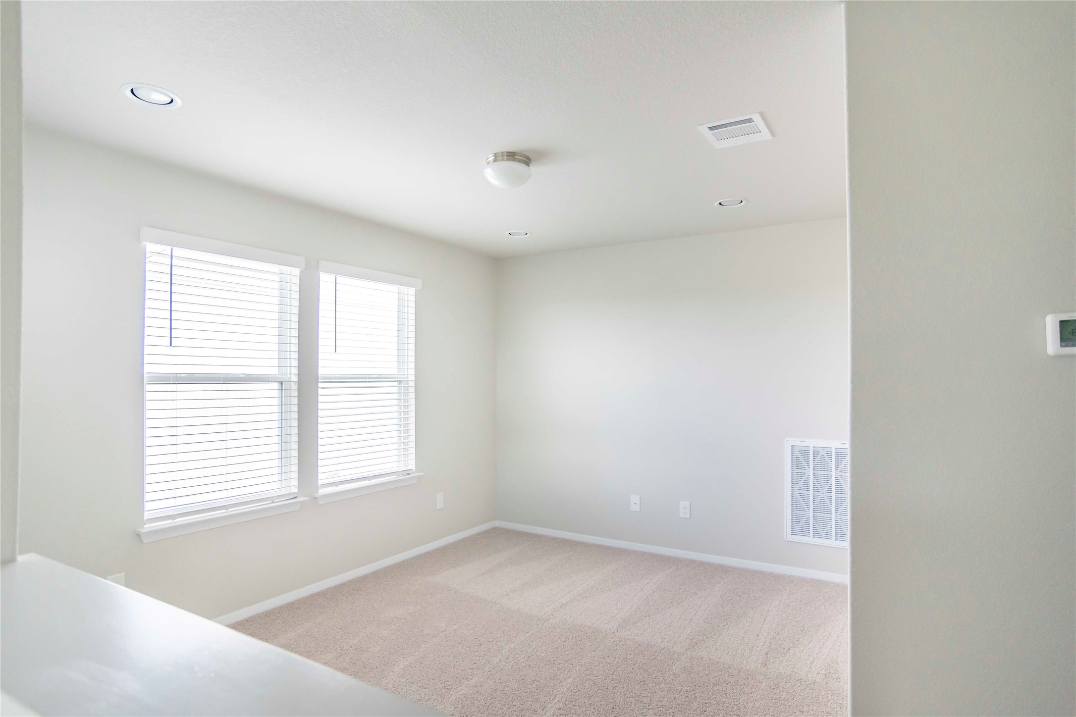 1257 Goforth Road Kyle, TX 78640 - Photo 14 of 33 Unfurnished bedroom featuring light carpet and recessed lighting