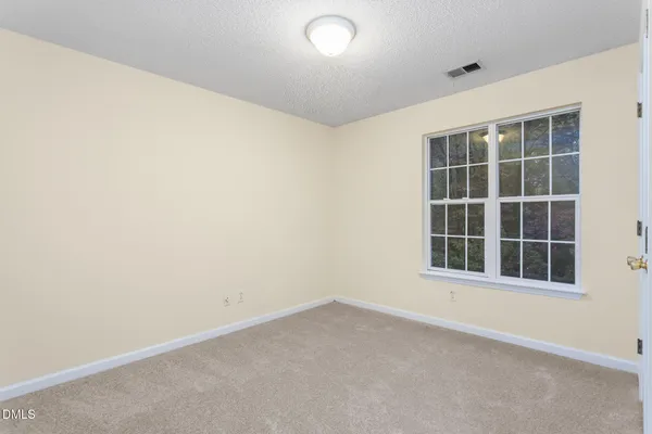 an empty room with closet area