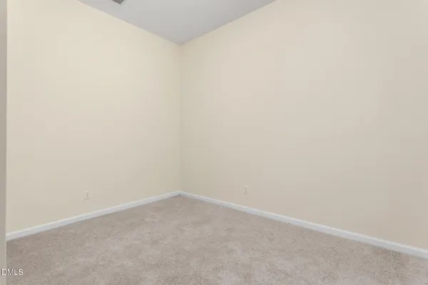 an empty room with closet area