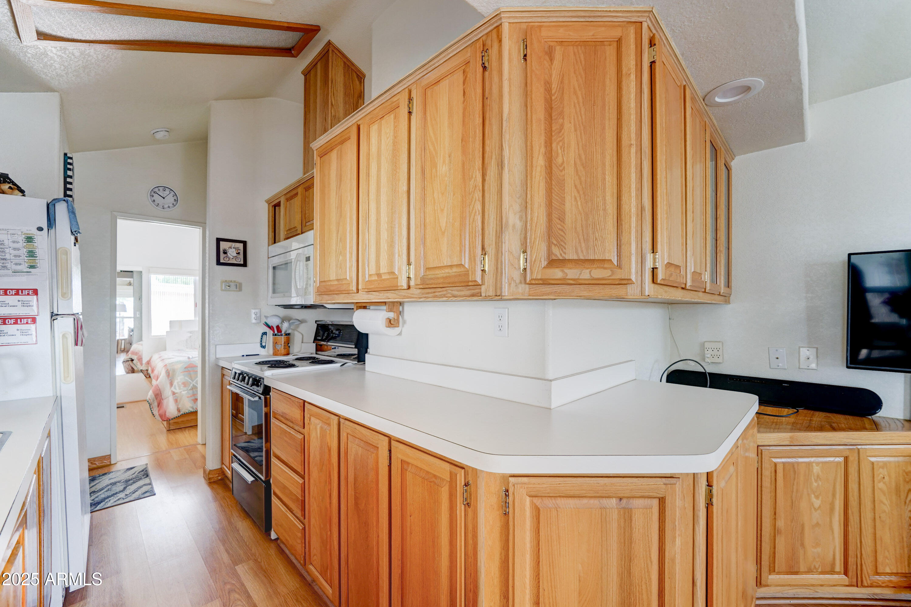 111 South Greenfield Road, Unit 552 Mesa, AZ 85206 - Photo 5 of 24 a kitchen with stainless steel appliances a refrigerator and a stove top oven