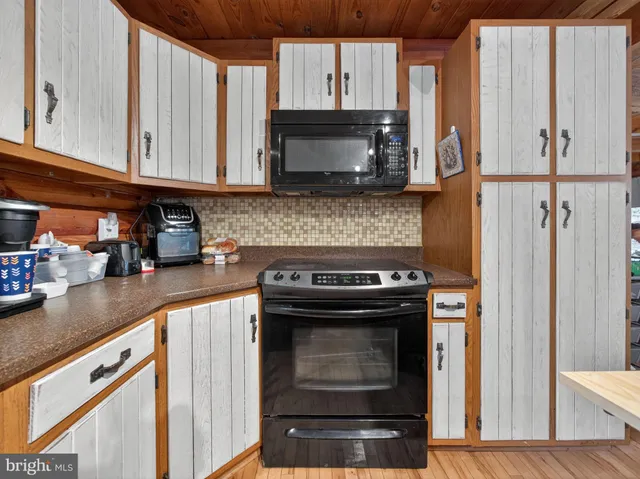 a kitchen with stainless steel appliances granite countertop a stove and a microwave
