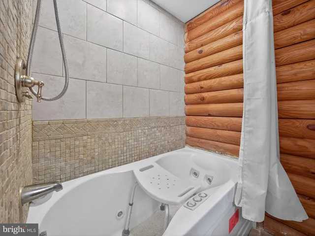 a bathroom with a bathtub and shower