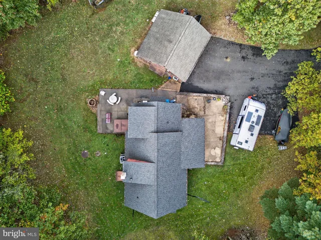 an aerial view of a house with a yard