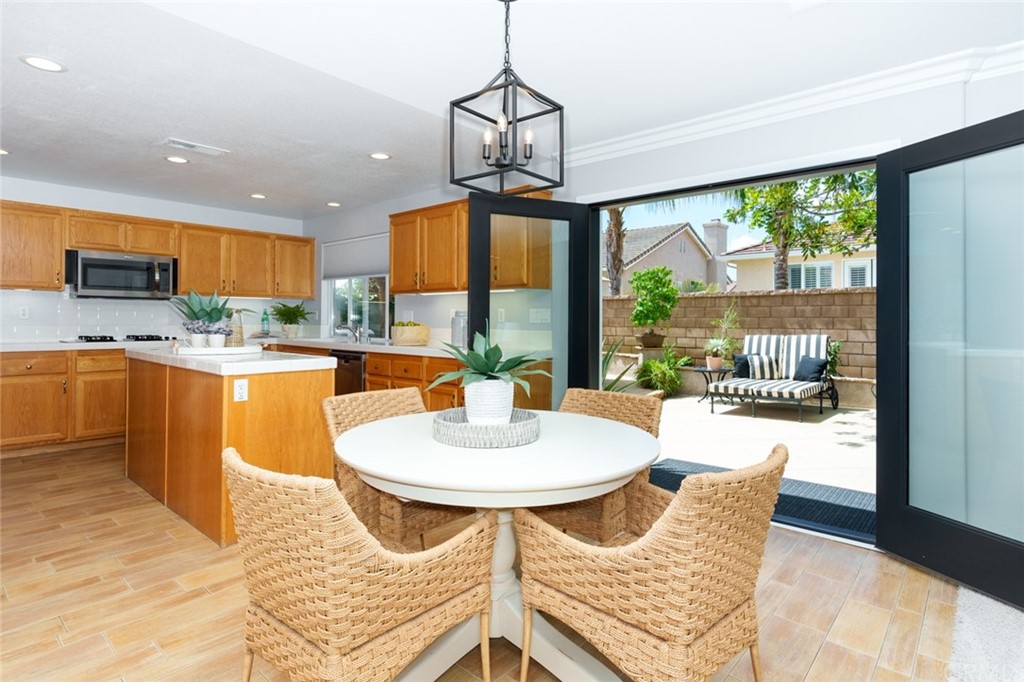 8 Elizabeth Lane Irvine, CA 92602 - Photo 10 of 41 a dining room with a large window table and chairs