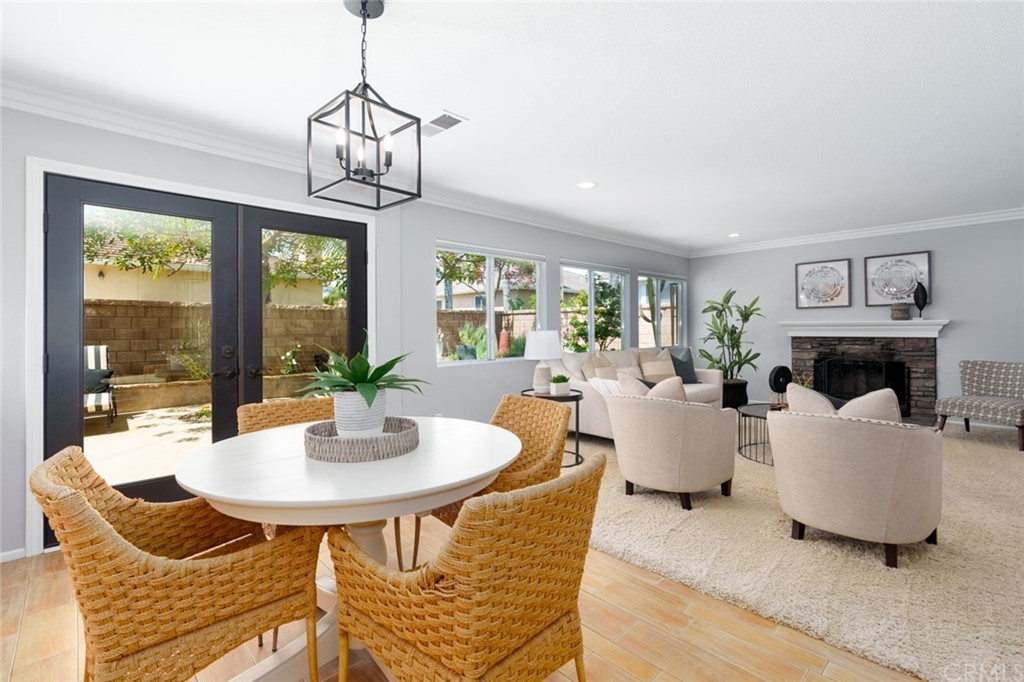 8 Elizabeth Lane Irvine, CA 92602 - Photo 13 of 41 a living room with fireplace furniture and a chandelier