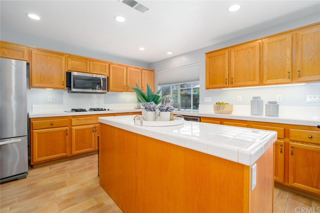 8 Elizabeth Lane Irvine, CA 92602 - Photo 14 of 41 a kitchen with stainless steel appliances granite countertop a sink stove and refrigerator