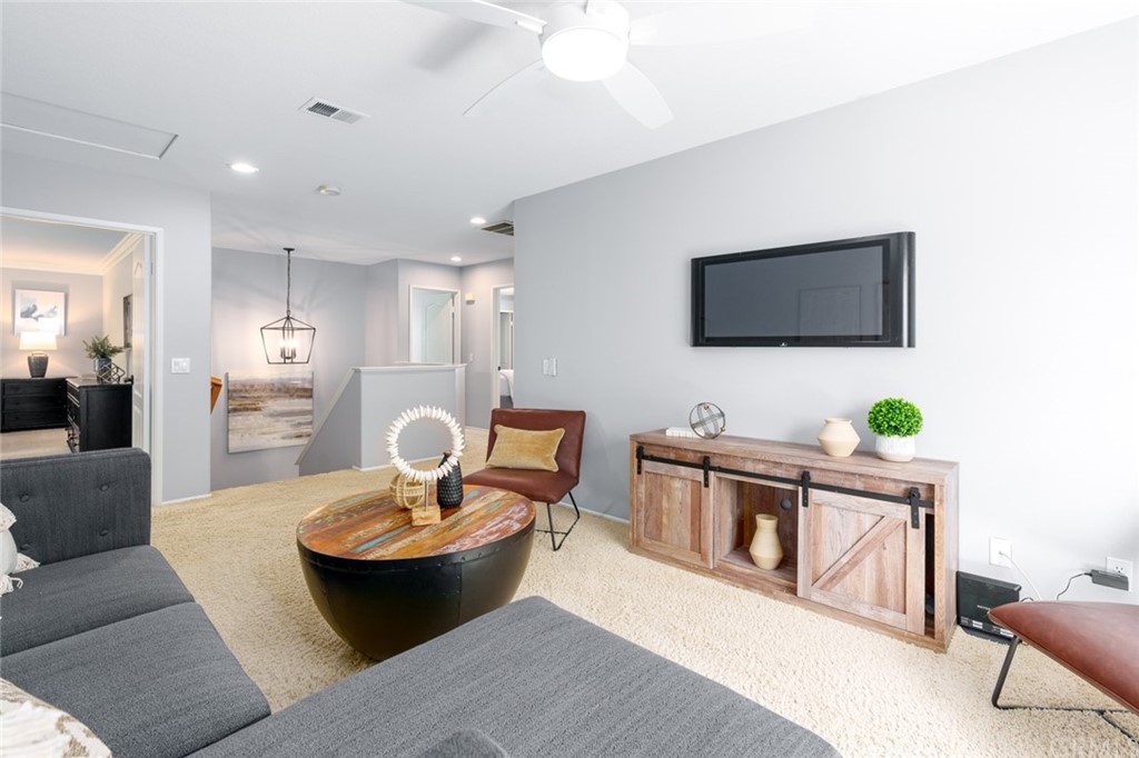 8 Elizabeth Lane Irvine, CA 92602 - Photo 18 of 41 a living room with furniture a flat screen tv and a dining table