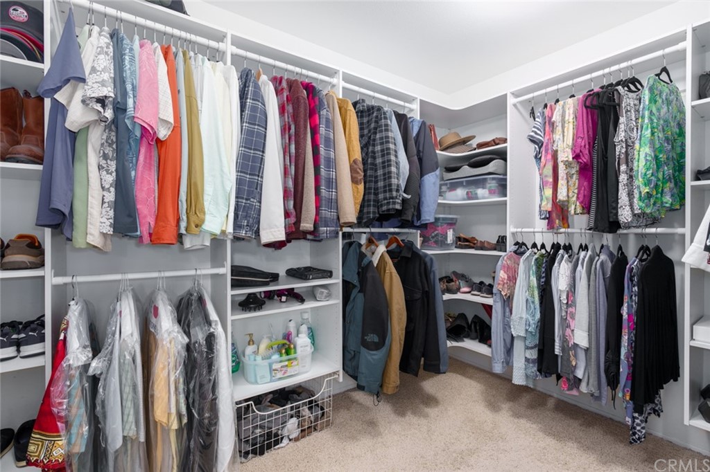 8 Elizabeth Lane Irvine, CA 92602 - Photo 24 of 41 a view of walk in closet with clothes and shoes