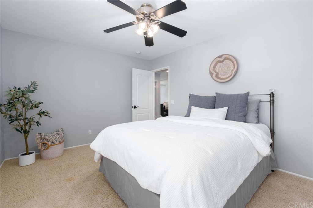 8 Elizabeth Lane Irvine, CA 92602 - Photo 26 of 41 a bedroom with bed and a chandelier