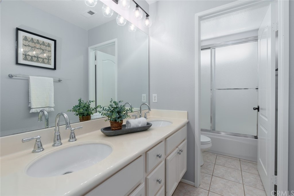 8 Elizabeth Lane Irvine, CA 92602 - Photo 27 of 41 a bathroom with a double vanity sink and mirror