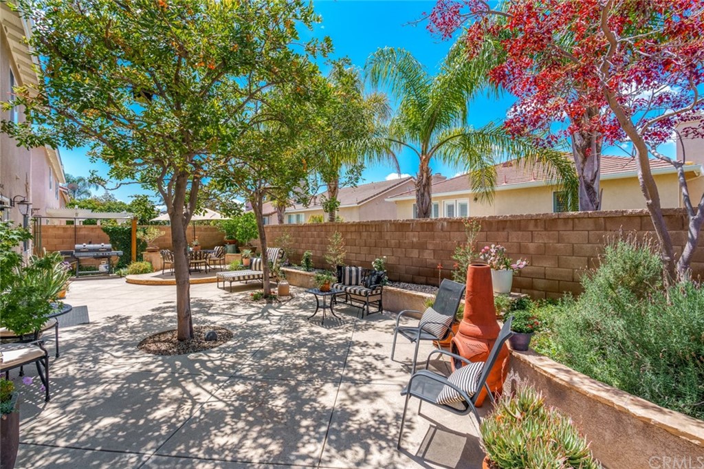 8 Elizabeth Lane Irvine, CA 92602 - Photo 32 of 41 a backyard of a house with table and chairs under an umbrella