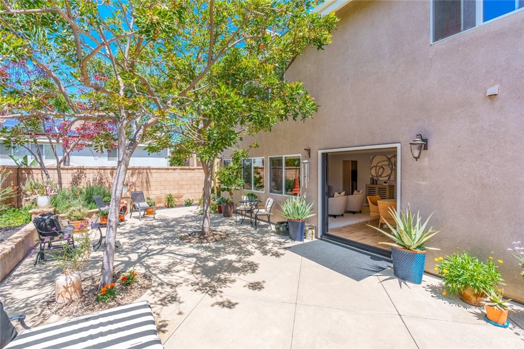 8 Elizabeth Lane Irvine, CA 92602 - Photo 34 of 41 a row of potted plants in front of a house