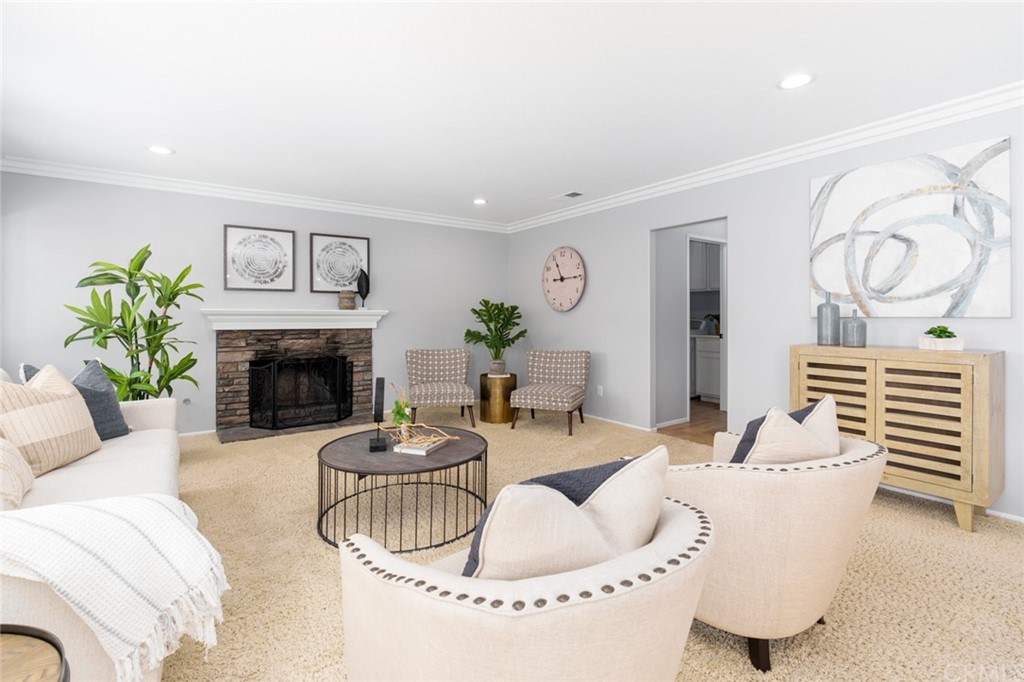 8 Elizabeth Lane Irvine, CA 92602 - Photo 6 of 41 a living room with furniture potted plant and a fireplace