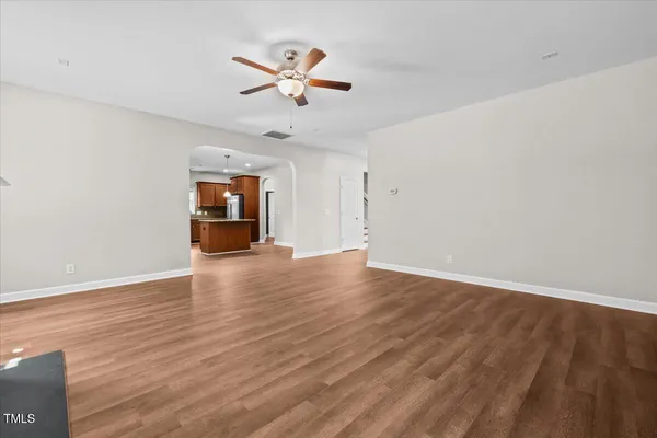 a kitchen with stainless steel appliances granite countertop a sink refrigerator and cabinets