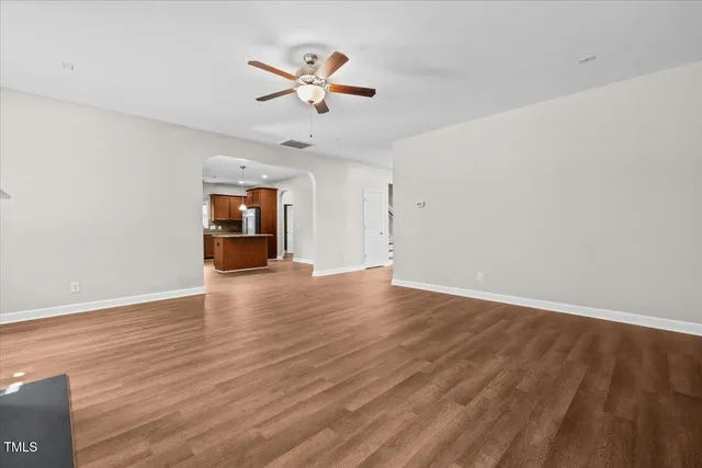 a kitchen with stainless steel appliances granite countertop a sink refrigerator and cabinets