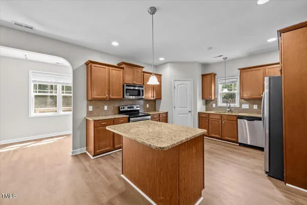 a kitchen with stainless steel appliances granite countertop cabinets and window