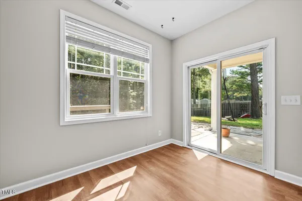 a view of an empty room with wooden floor