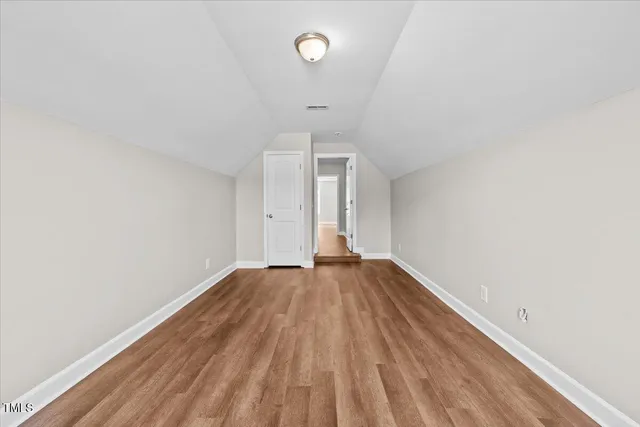 a white toilet sitting next to a white wall