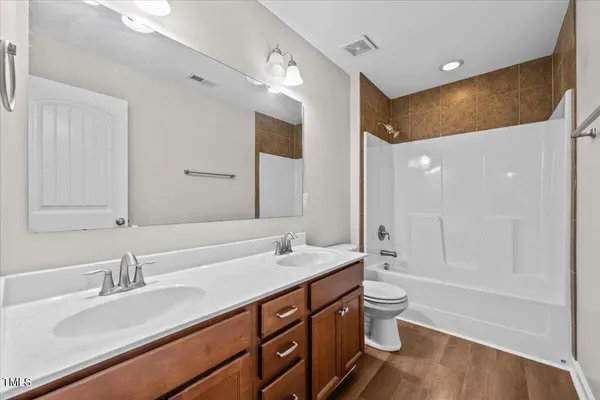 a view of a house with a big yard and a large tree