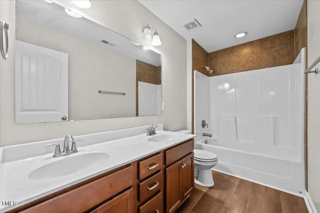 a view of a house with a big yard and a large tree