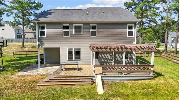 a swimming pool with lots of trees and green space