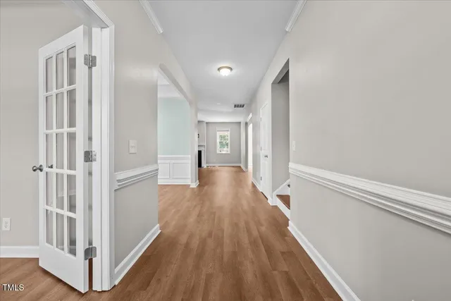 a view of a hallway with wooden floor