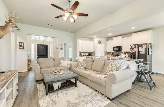 a living room with furniture and a chandelier