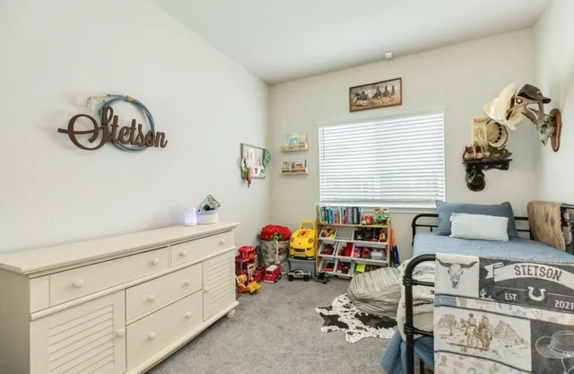a bedroom with furniture and a window