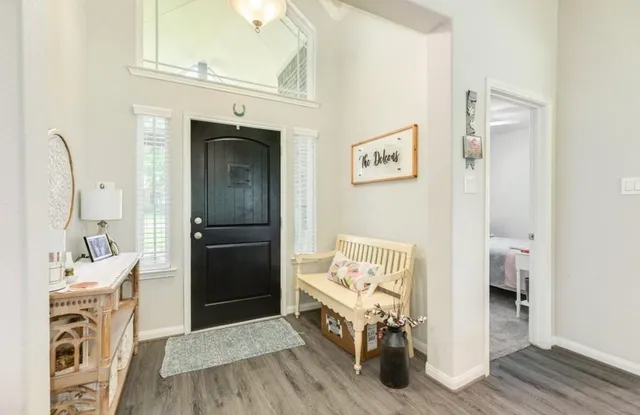 a view of a livingroom with furniture and front door