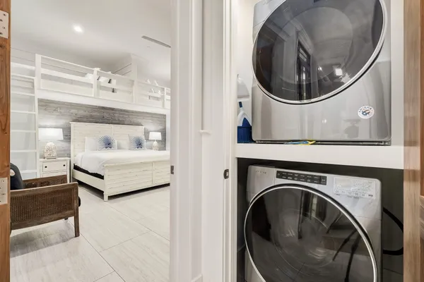 a bathroom with a granite countertop toilet a sink a mirror and shower