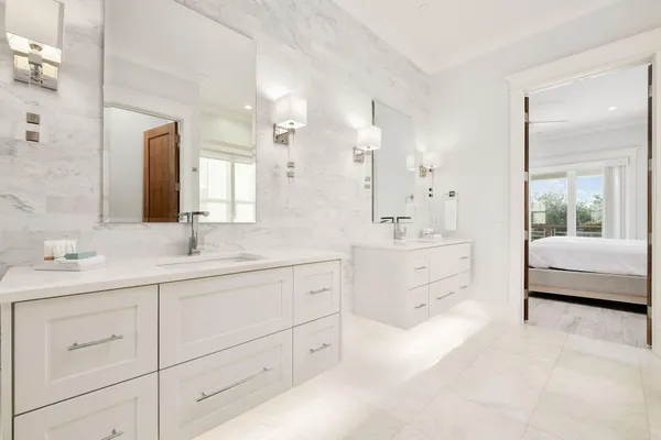 a bathroom with a granite countertop sink mirror and a bathtub