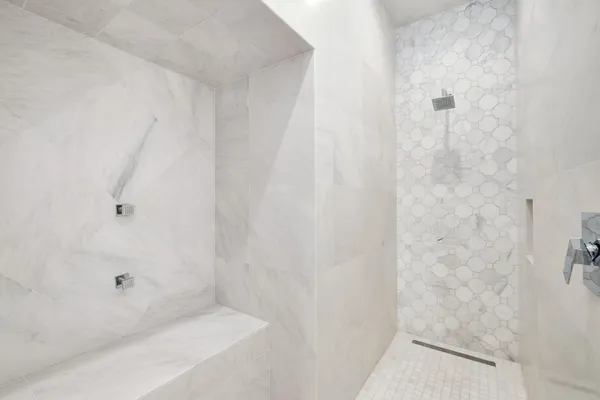 a spacious bathroom with a bathtub shower sink double and mirror