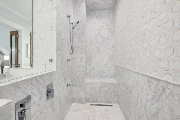 a bathroom with a sink a toilet and a large mirror