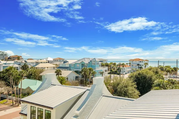 a front view of multiple houses with yard