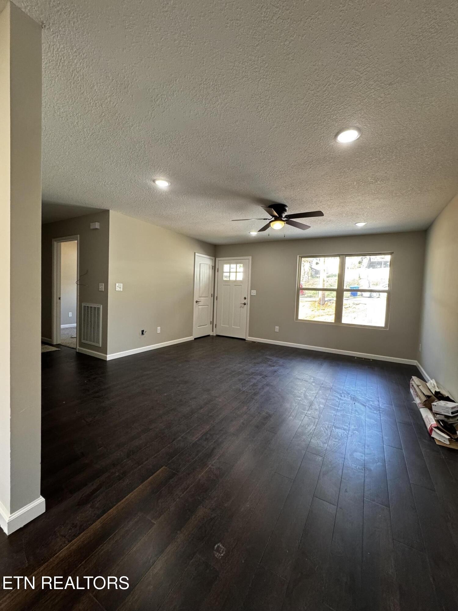 129 East Wadsworth Circle Oak Ridge, TN 37830 - Photo 3 of 13 an empty room with wooden floor and windows