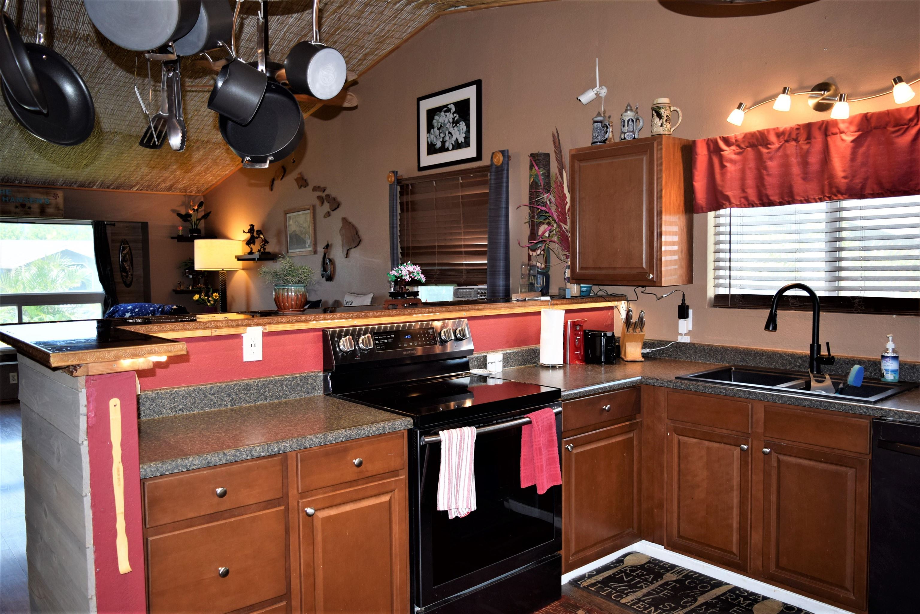225 Humupea Street Kihei, HI 96753 - Photo 14 of 28 a kitchen with stainless steel appliances granite countertop a stove a sink and a microwave