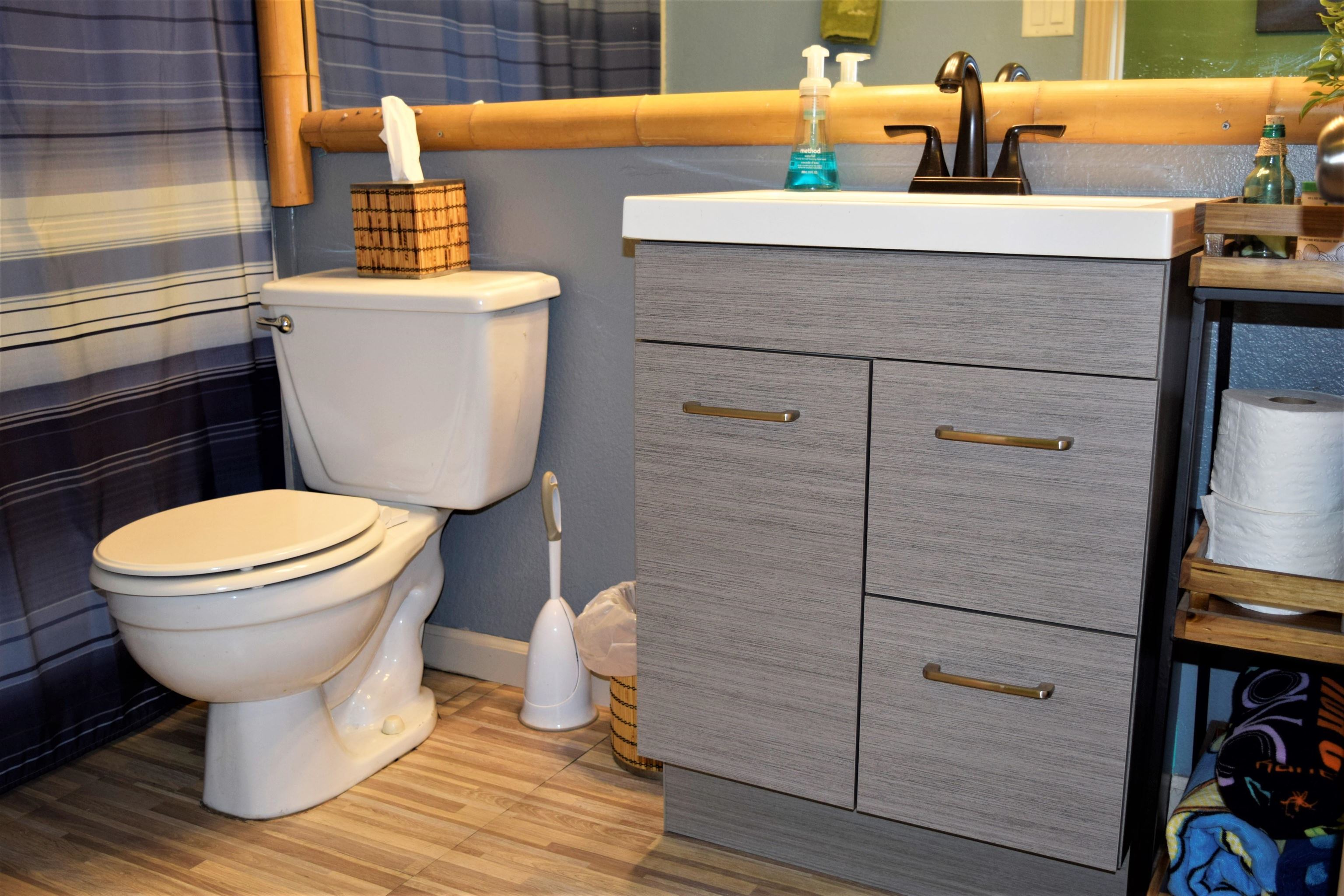 225 Humupea Street Kihei, HI 96753 - Photo 19 of 28 a bathroom with a sink and a toilet