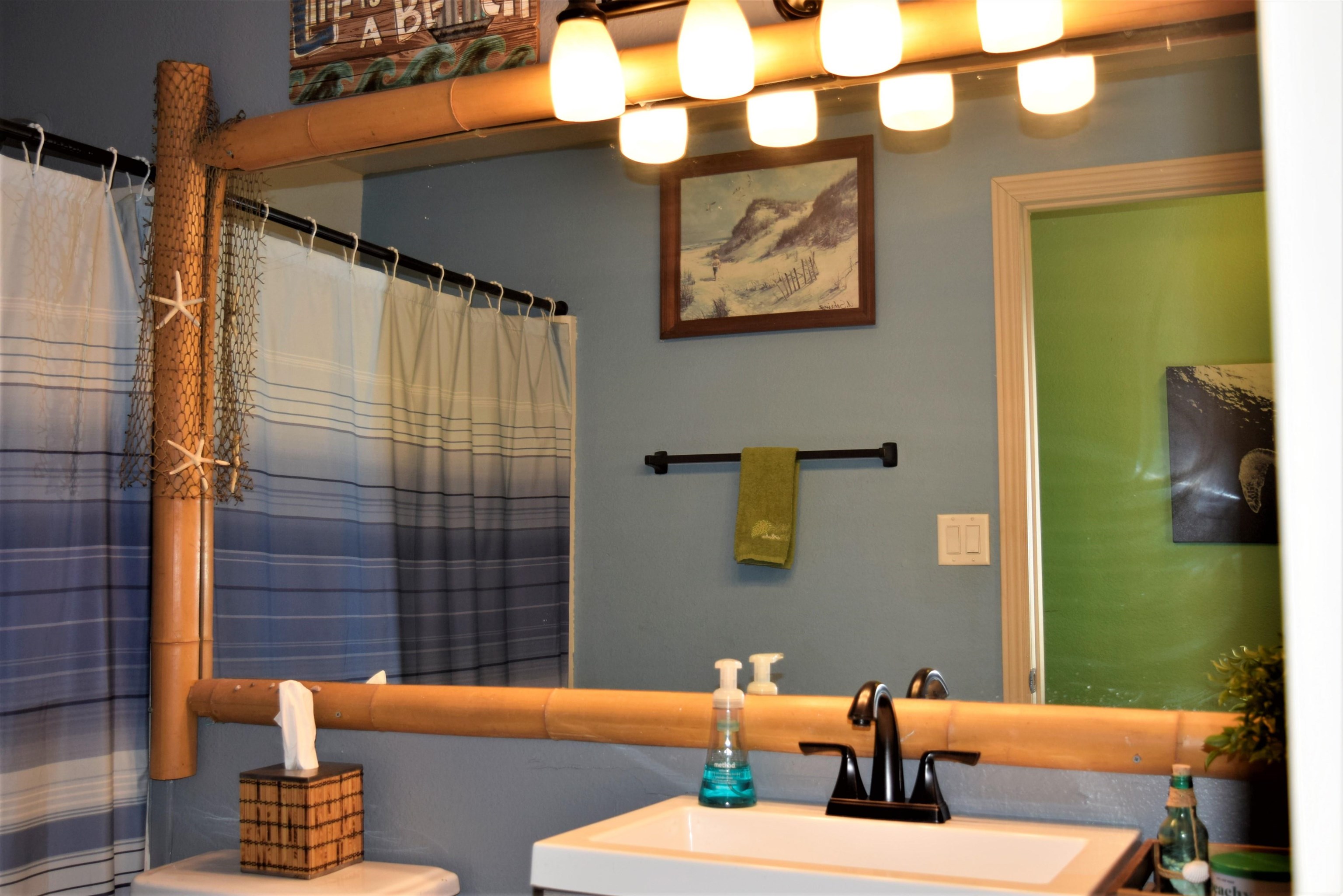 225 Humupea Street Kihei, HI 96753 - Photo 20 of 28 a bathroom with a sink a mirror and a shower