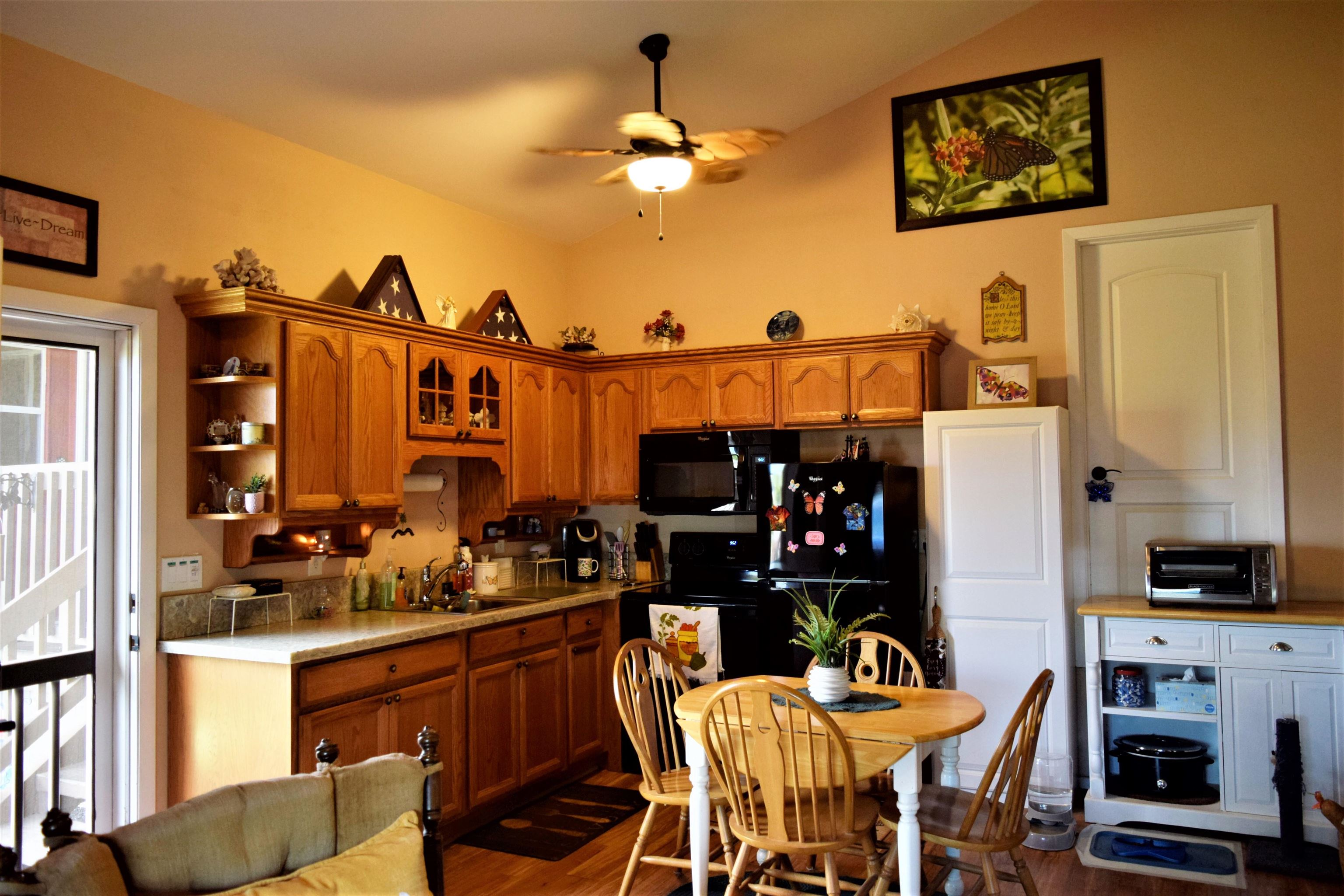 225 Humupea Street Kihei, HI 96753 - Photo 25 of 28 a kitchen with a refrigerator and cabinets