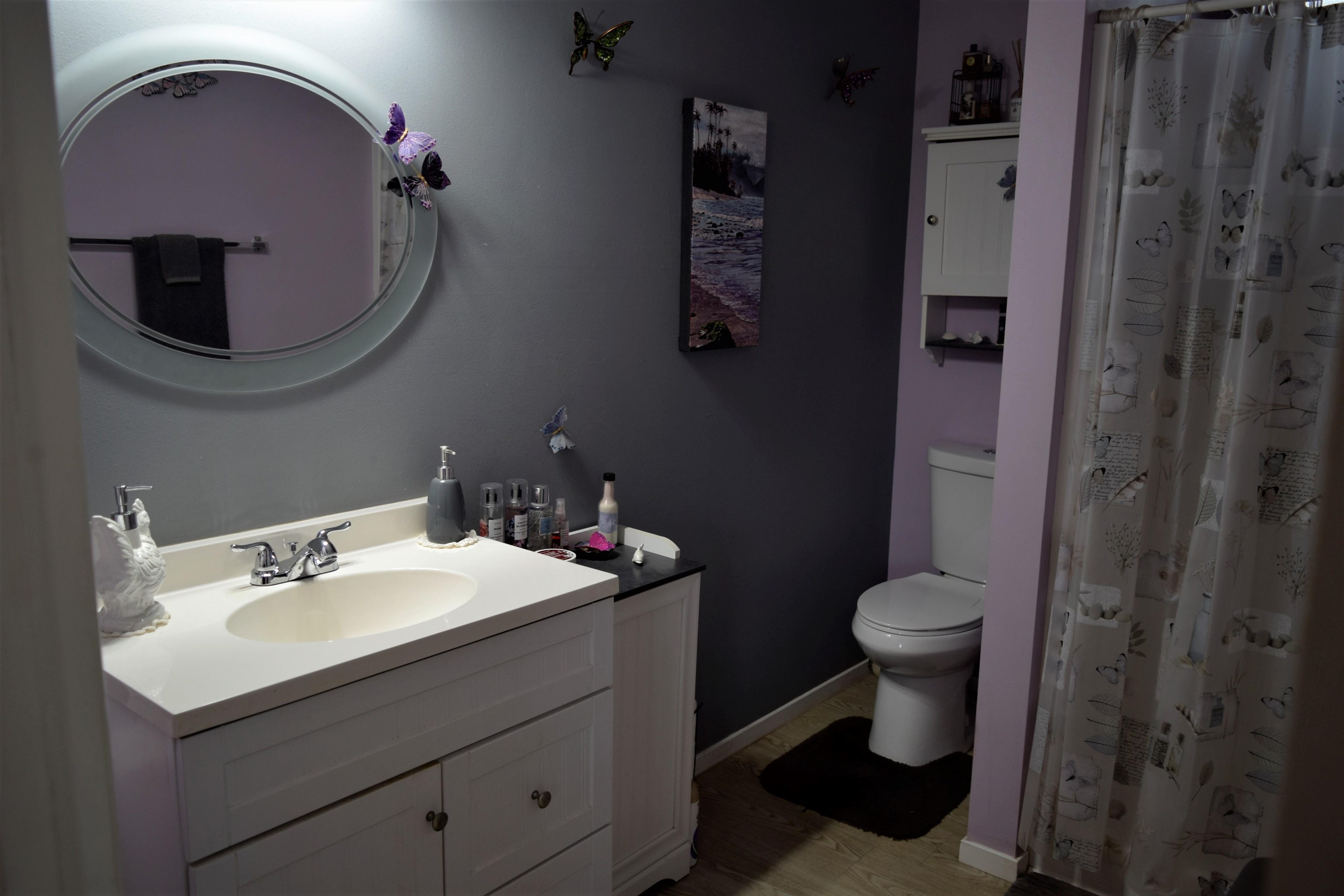 225 Humupea Street Kihei, HI 96753 - Photo 26 of 28 a bathroom with a sink mirror vanity and toilet