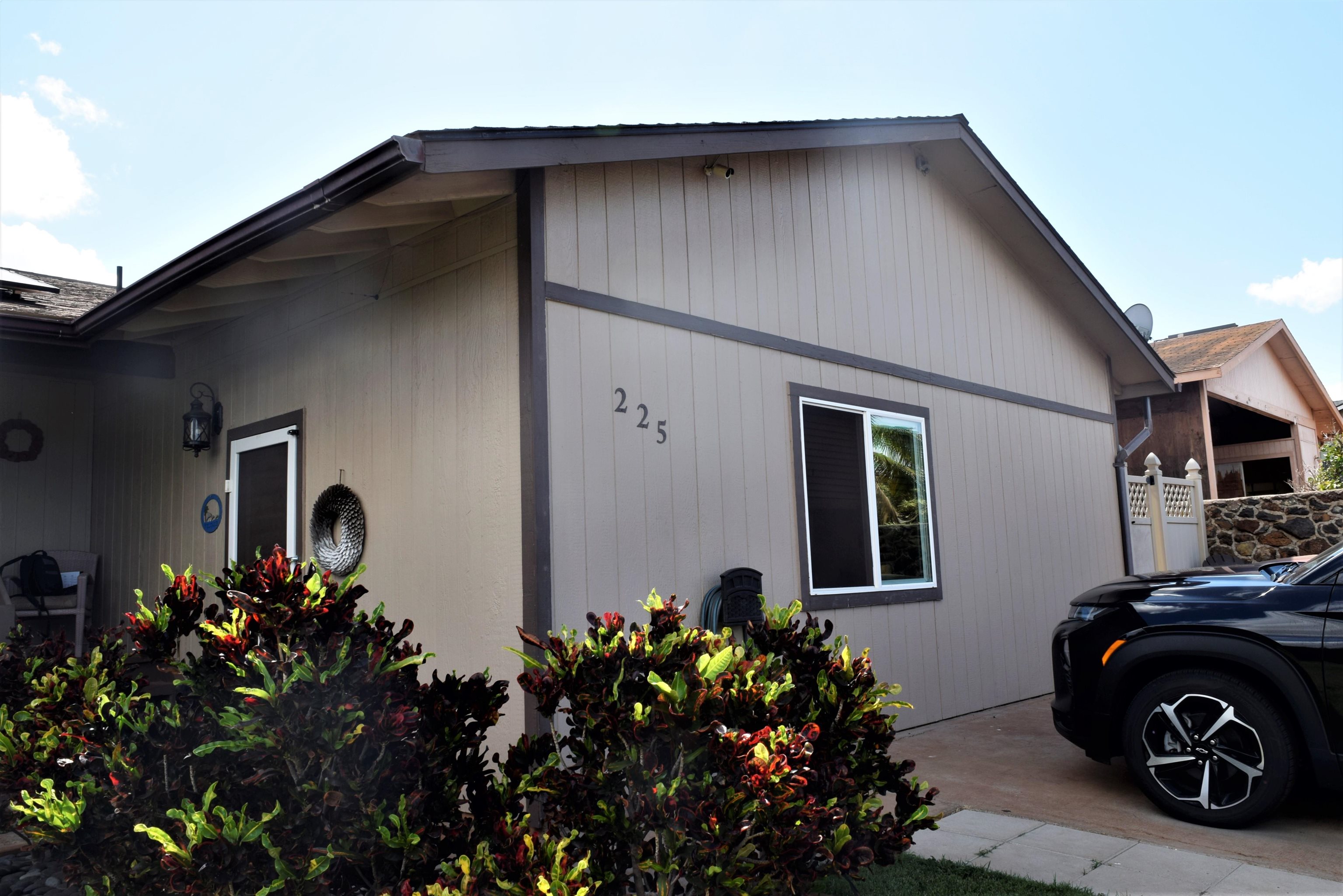 225 Humupea Street Kihei, HI 96753 - Photo 3 of 28 a front view of a house with a garden
