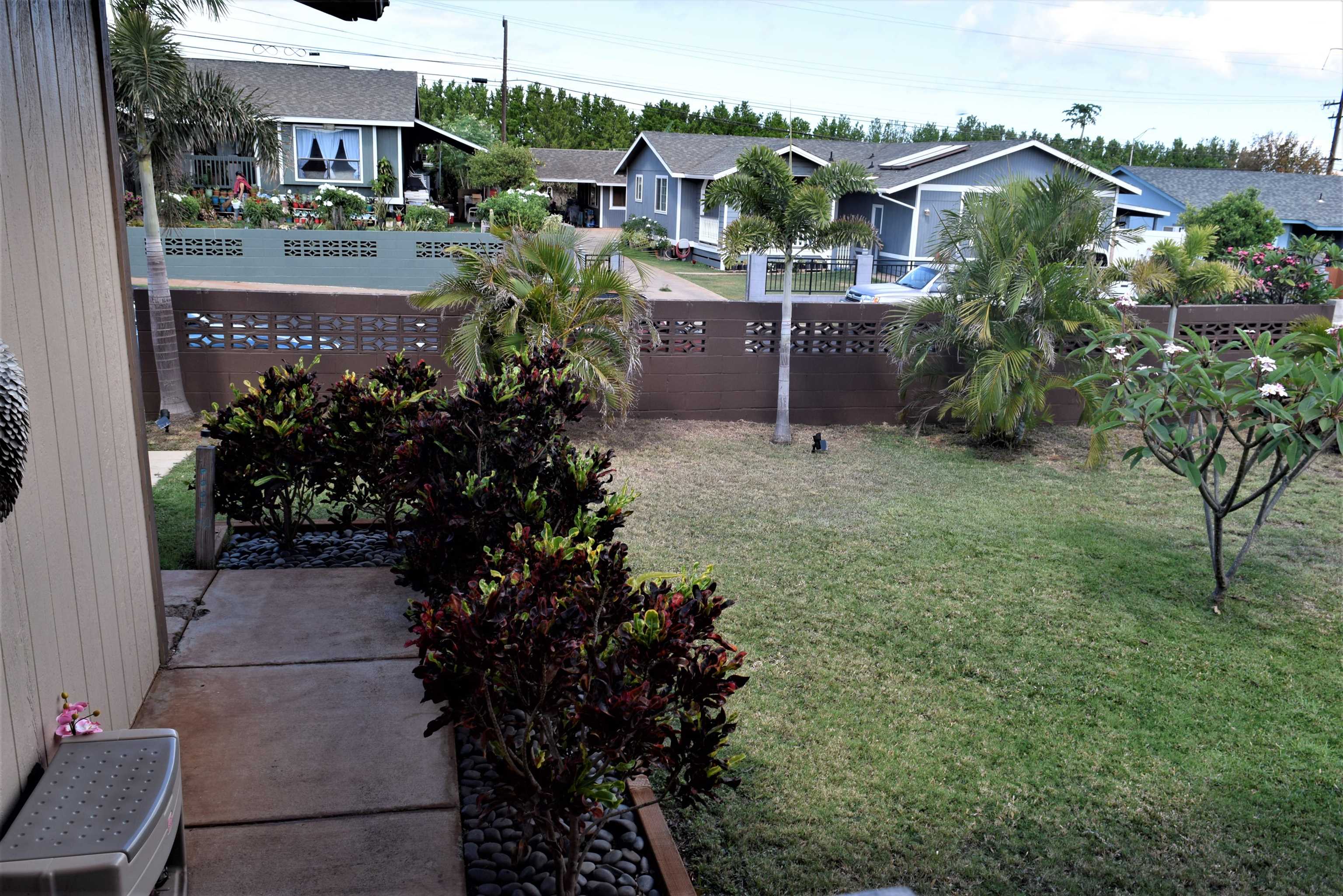 225 Humupea Street Kihei, HI 96753 - Photo 4 of 28 a view of house with a yard and potted plants